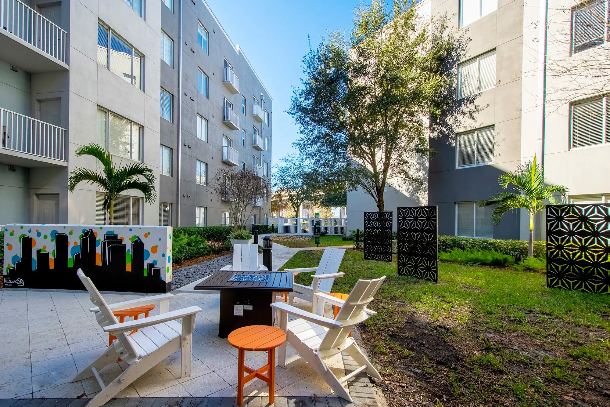 Courtyard fire pit with chairs and side table.